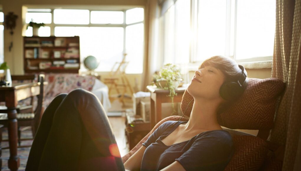 Young woman relaxing with headphones at home